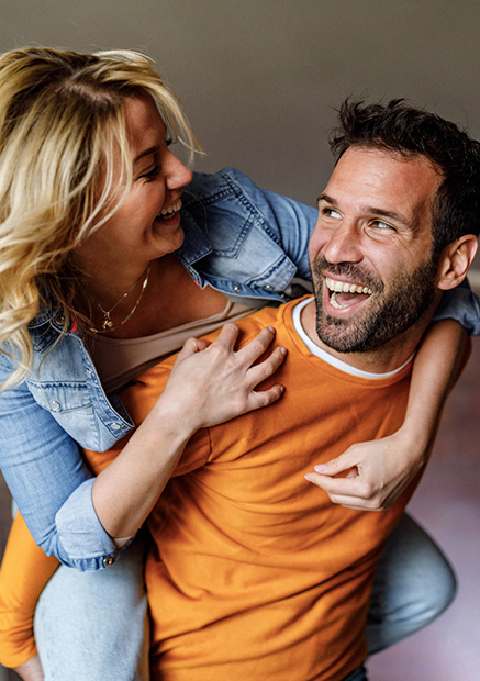 Couple playing and smiling at each other.